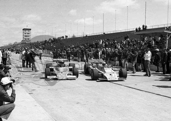 Hiss hits official Walt Meyers first day of practice Indy 1974.  Bigelow #27